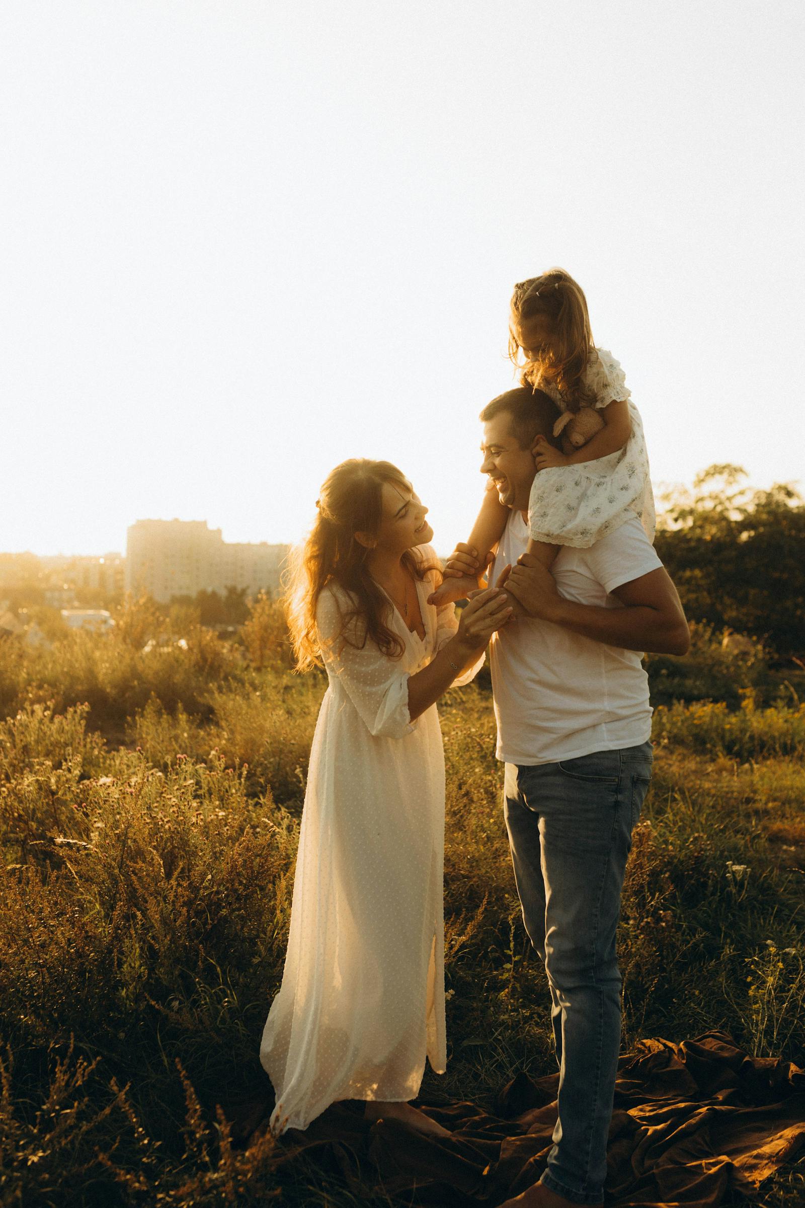 Happy family together at sunset
