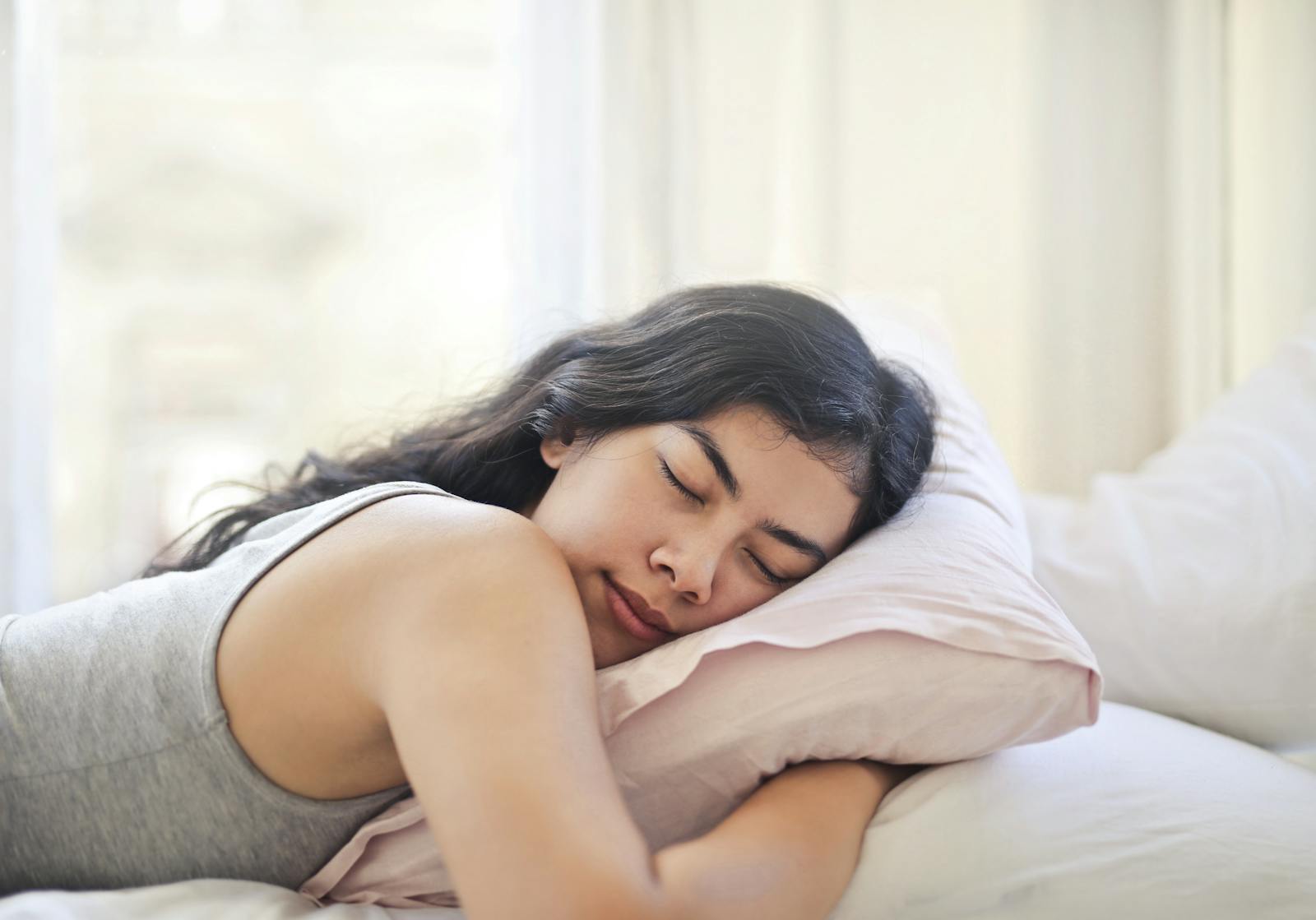 Woman resting peacefully in bed