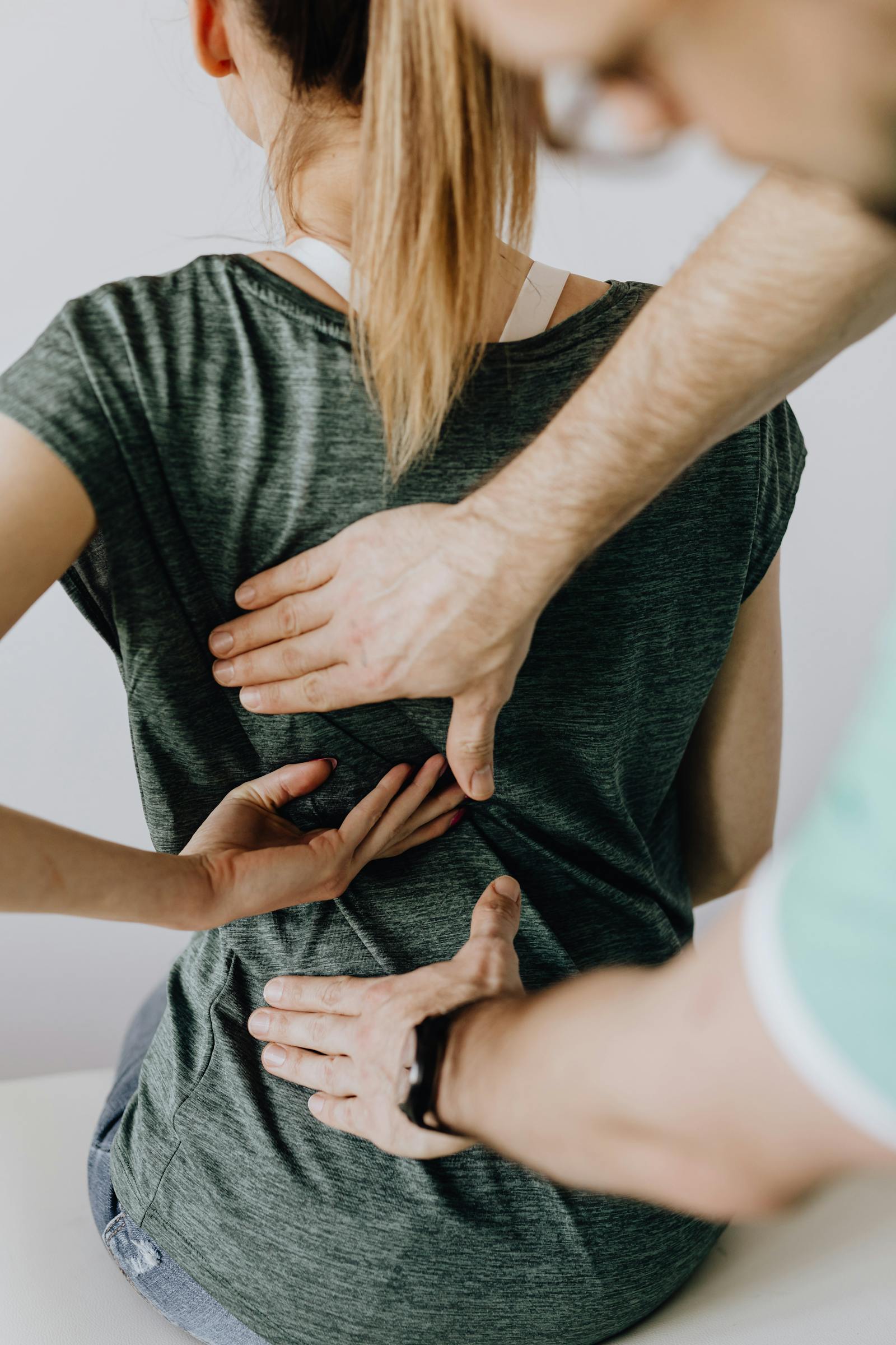 Chiropractor examining a patient's back