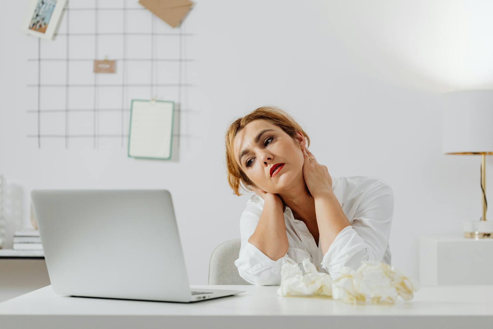 Tired person at a laptop with neck strain