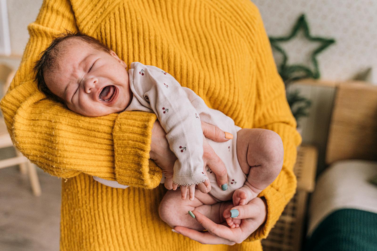 Crying infant being comforted