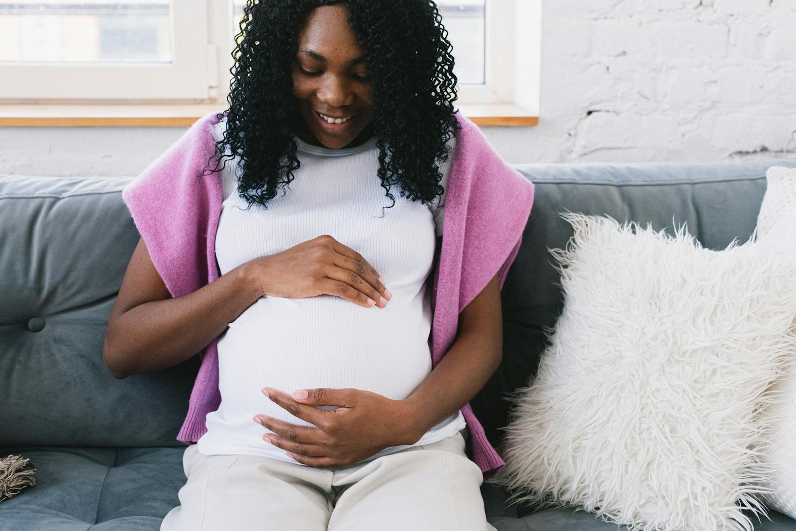 Relaxed pregnant woman resting comfortably on a couch