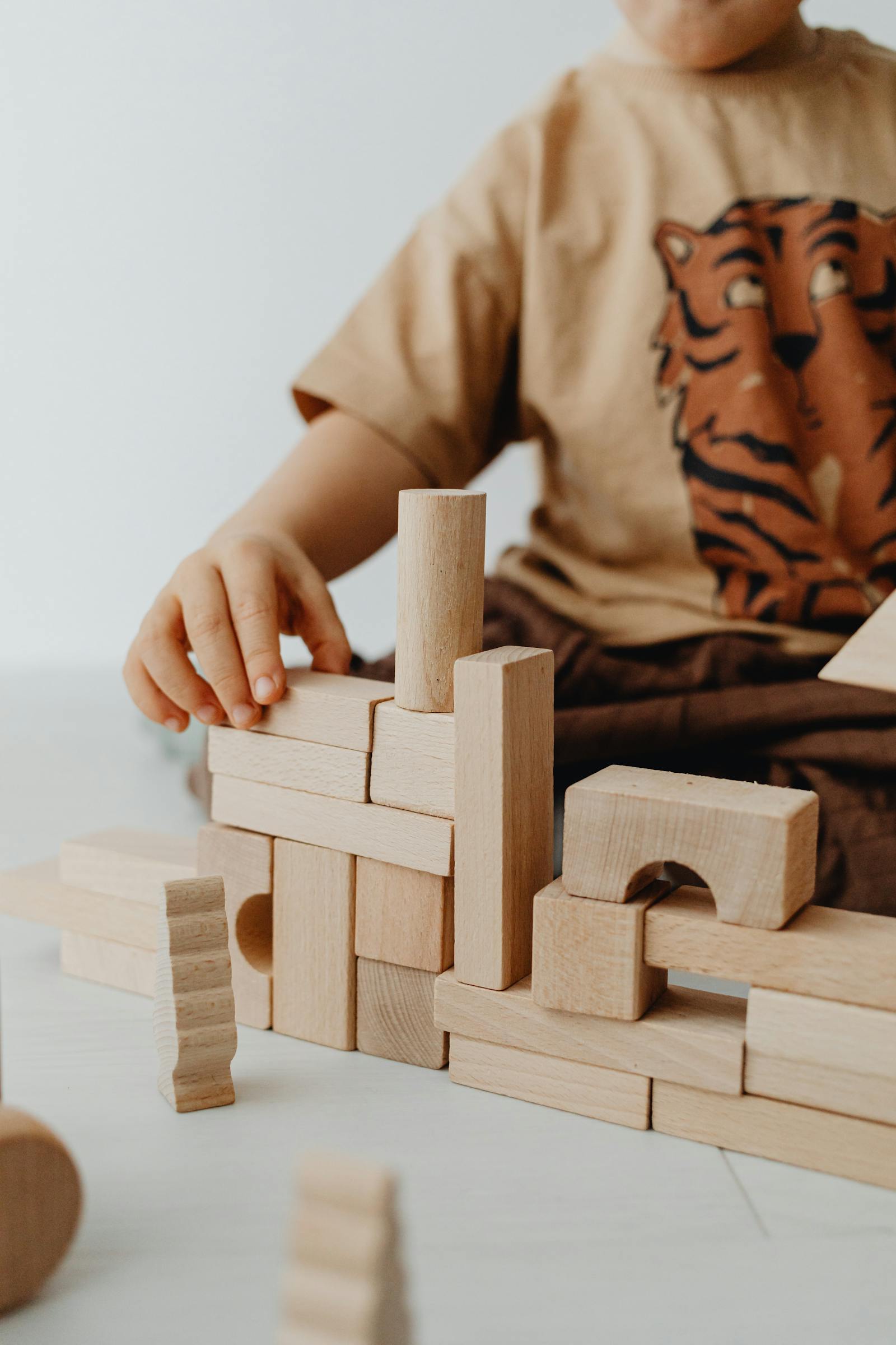 Kid concentrating while building with blocks