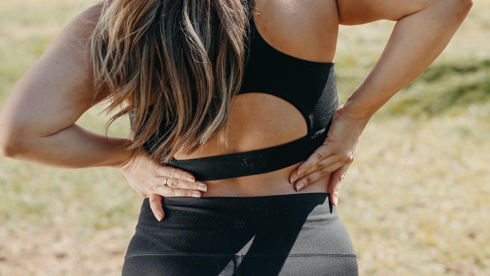 Woman holding her lower back