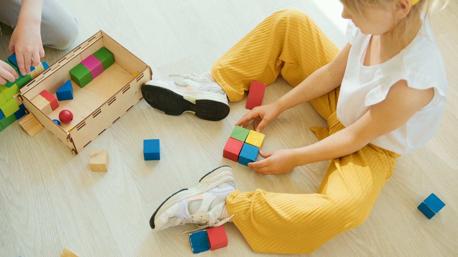 Child focused on stacking building blocks