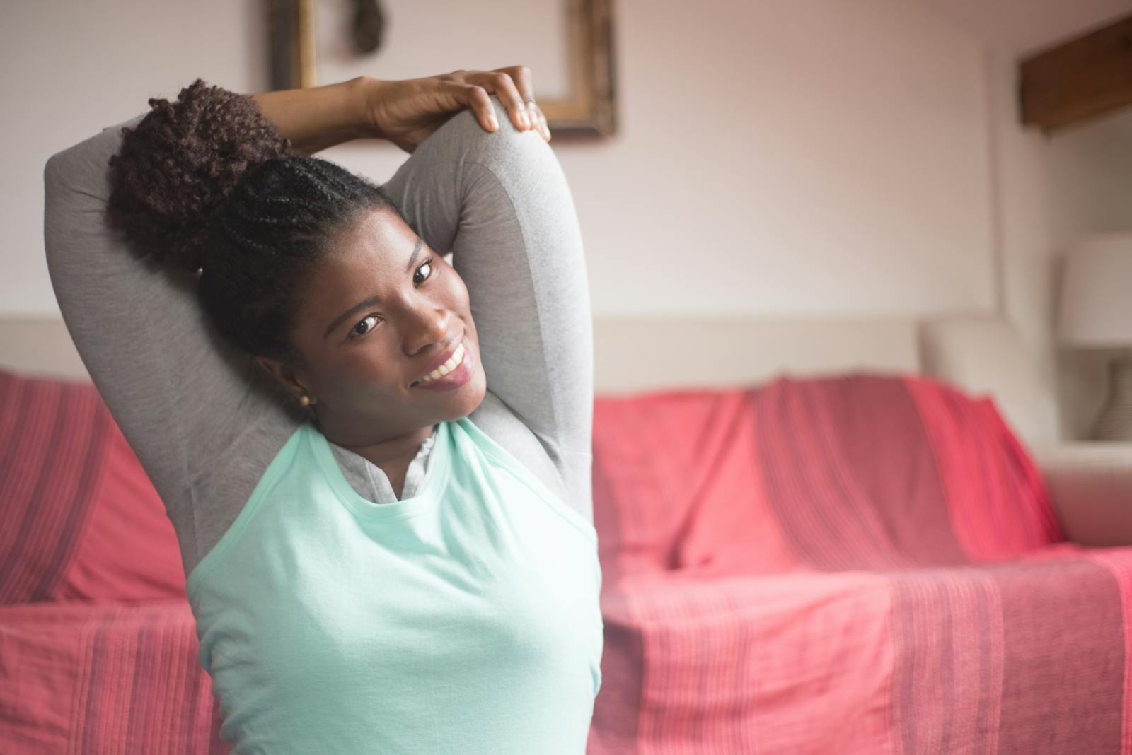 Woman doing a standing stretch at home